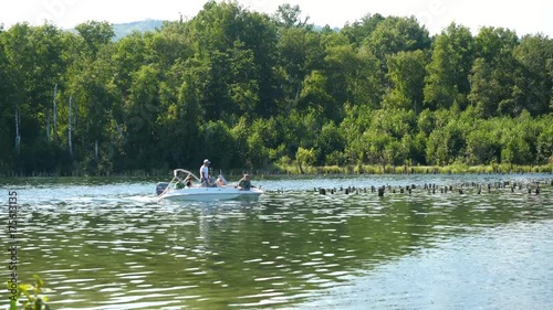 Lovers ride in a boat on a lake. Friends together relaxing on the water. The beautiful nature around photo