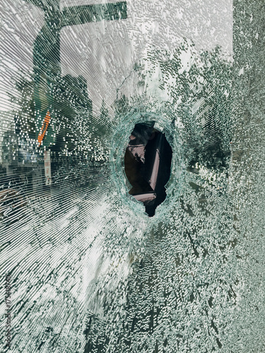 Hole in broken shattered glass window