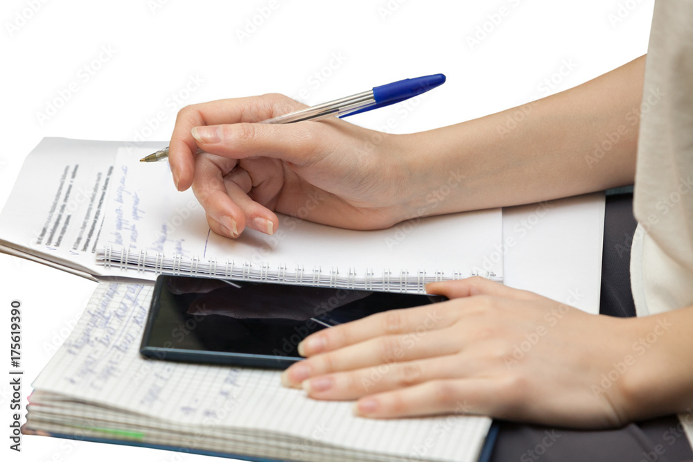 Fototapeta premium Female hands write in diary isolated