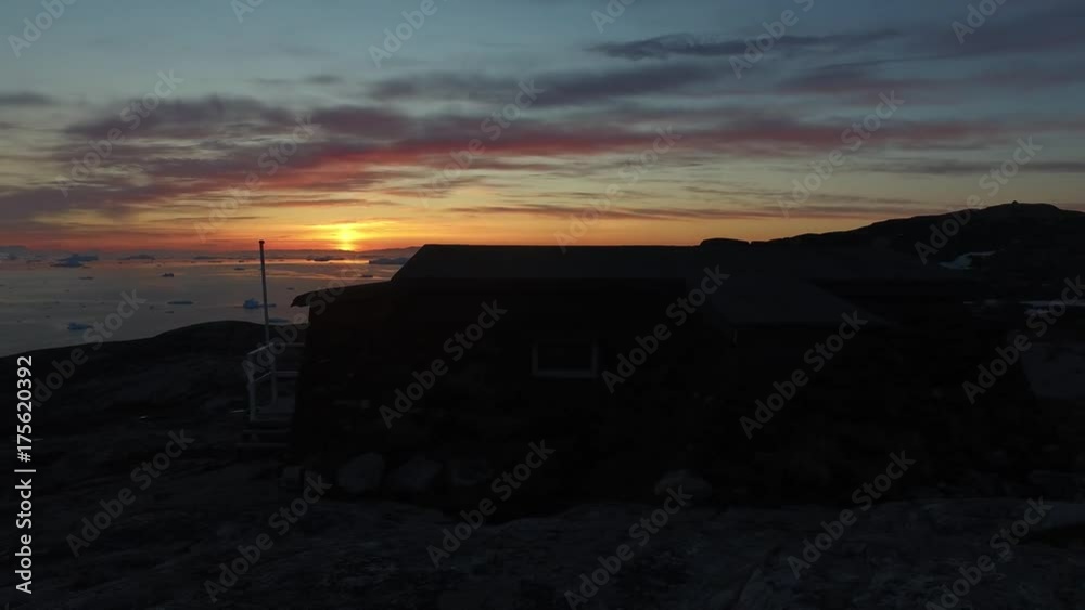 Sunset time to Ilulissat bay in Greenland, Arctic Icebergs on the arctic sea.