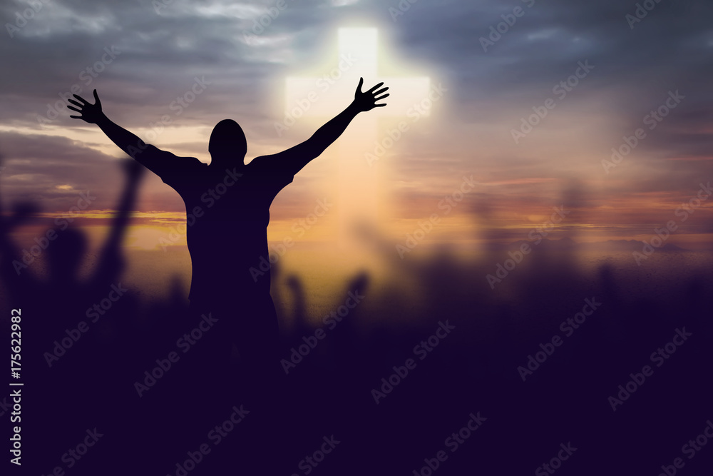 Silhouette of Christian prayers raising hand while praying to the Jesus