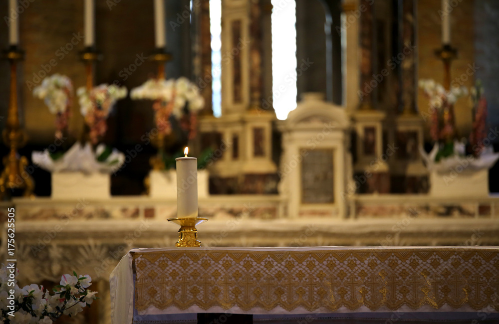 inside a church with the altar and candle lit