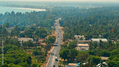 Wallpaper Mural Cinematic aerial of busy traffic on streets of city of Dar es Salaam by Indian ocean in Tanzania, Africa. Cars, busses, motorcycles, pedestrians, lush, green vegetation, palm trees, hot summer day Torontodigital.ca