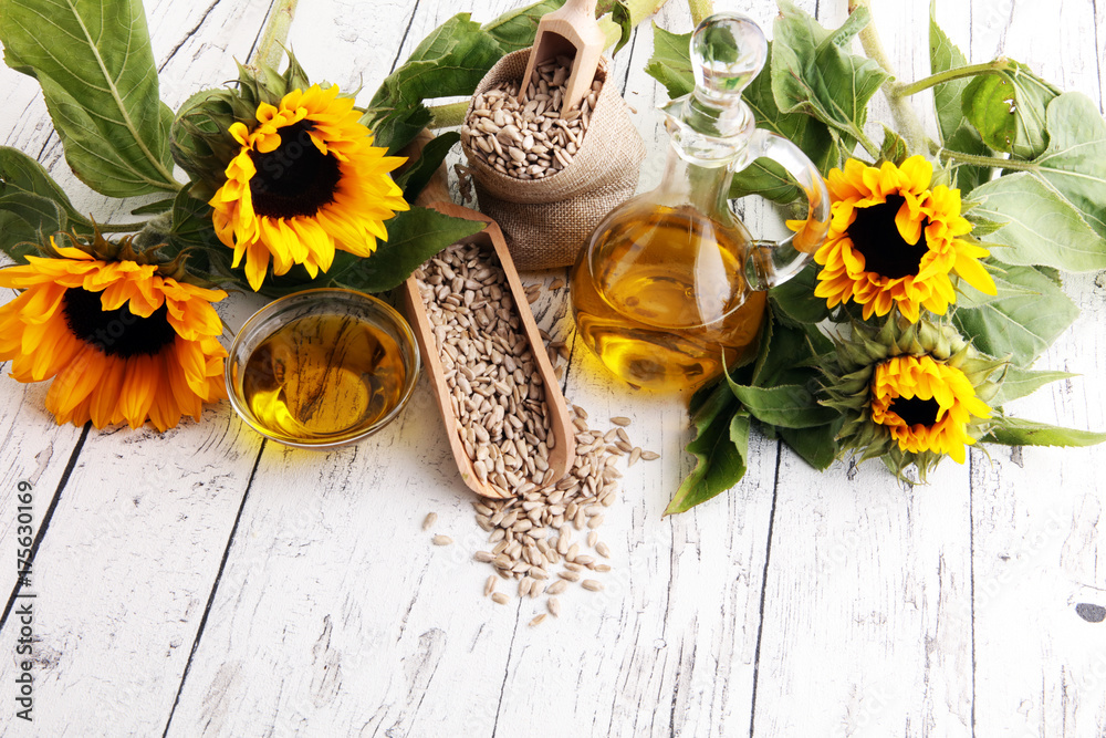 Sunflower oil, sunflower and seeds on white background Sunflower oil, sunflower and seeds on white background