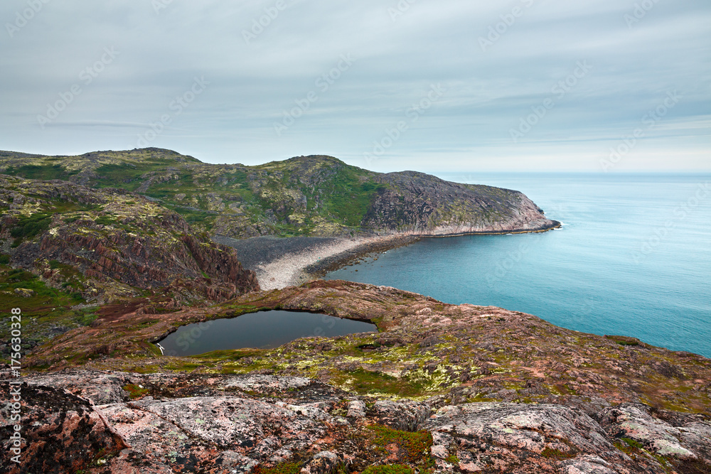 View on the rocky shore of the Barents sea. Kola Peninsula, The Arctic, Russia.