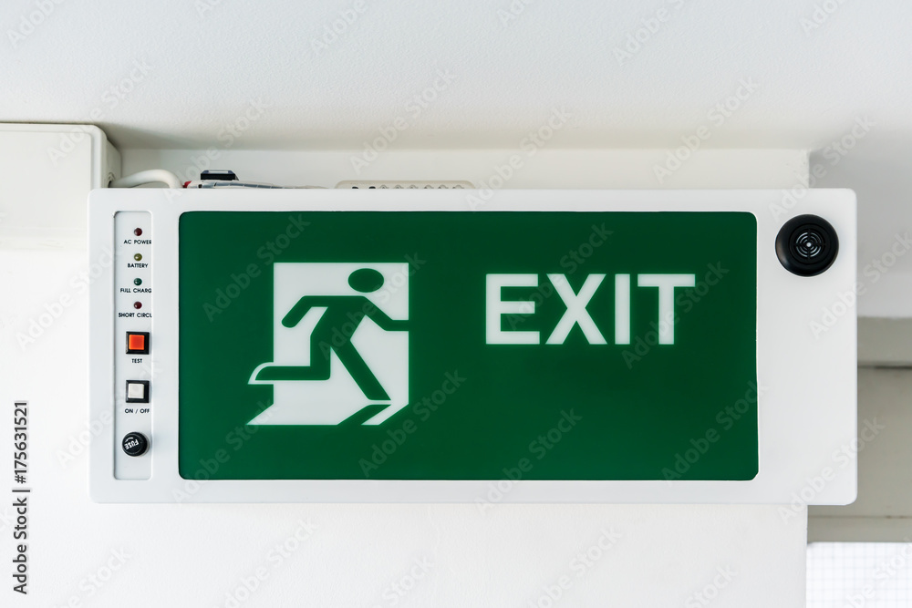 Green emergency exit sign. Direction to the escape way. Green emergency exit sign. Direction to the escape way.