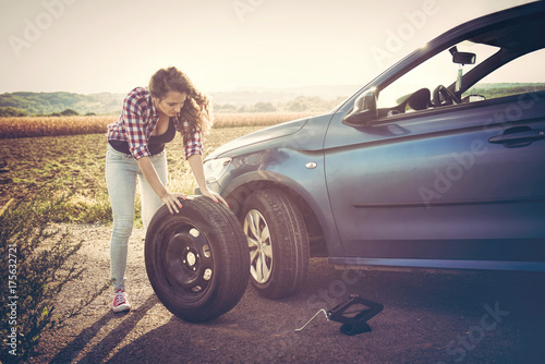 Beautiful young woman on the road, problem with her car