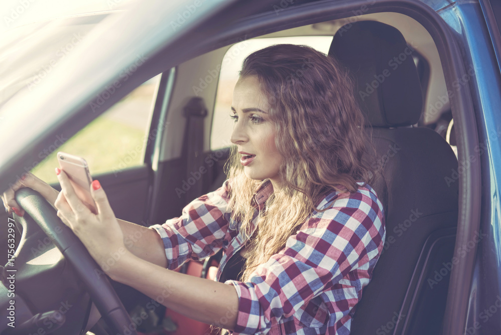 Naklejka premium A nervous young woman in the car