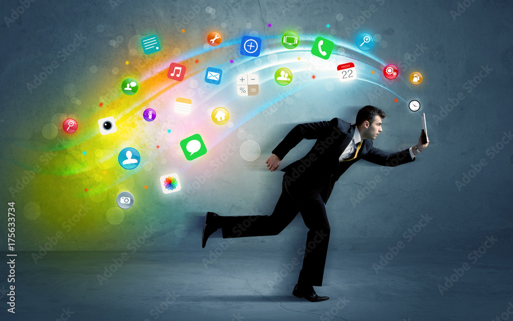 Running businessman with application icons from device Running businessman with application icons from device