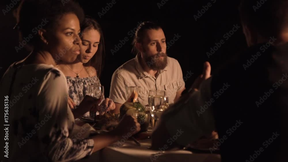 Bearded men sitting at table talking and dinning with friends. Bearded men sitting at table talking and dinning with friends.