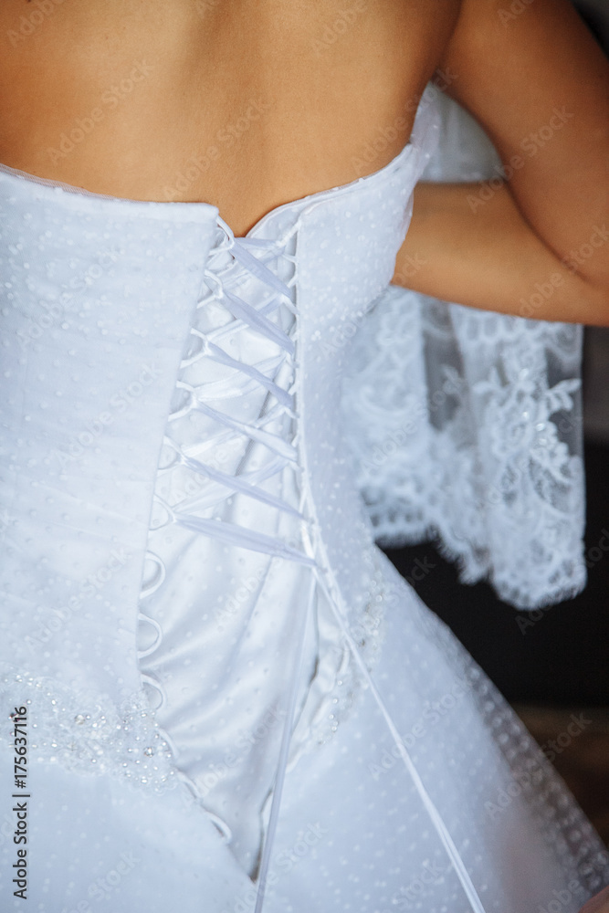 Wedding. Bride in a beautiful dress, close-up, like at home. Fashionable wedding style is shot close-up. Young attractive brunette model, like bride, corset Wedding. Bride in a beautiful dress, close-up, like at home. Fashionable wedding style is shot close-up. Young attractive brunette model, like bride, corset