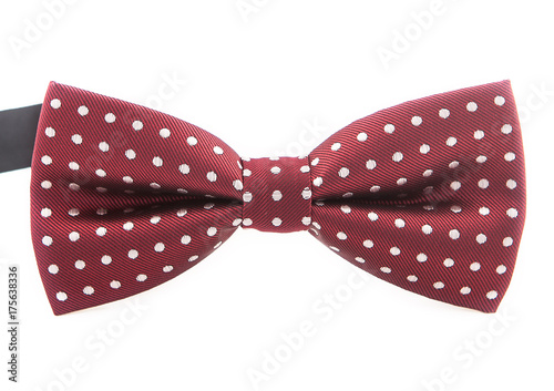 Elegant dark red bow tie with white polka dots on an isolated white background