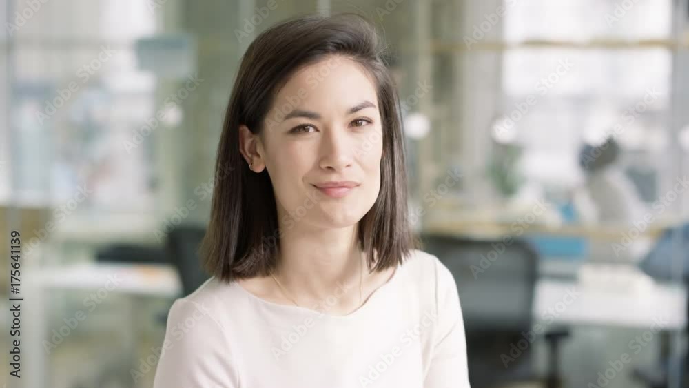 Portrait smiling casual businesswoman in modern creative office Portrait smiling casual businesswoman in modern creative office