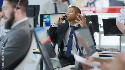  Financial trader in busy trading room negotiating a difficult deal over phone