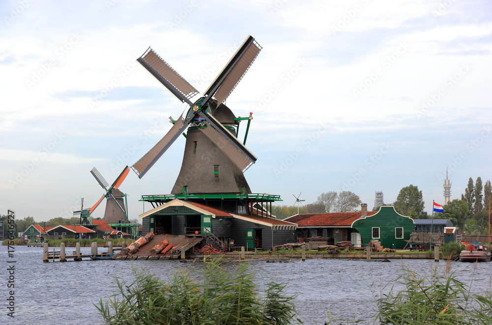 Traditional Dutch windmills on the water channel. Zaandam, the Netherlands. 