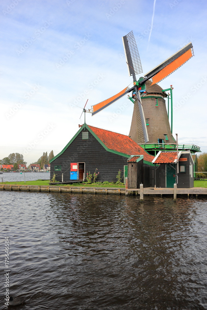 Traditional Dutch windmill on the water channel. Zaandam, the Netherlands. 