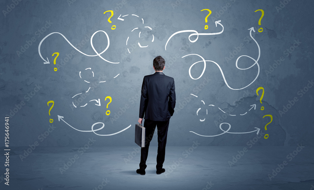 Unsure businessman with question marks Unsure businessman with question marks
