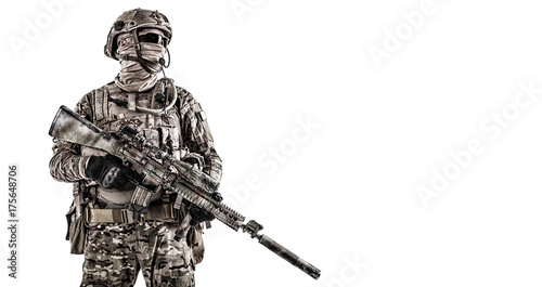 Half length low angle studio shot of special forces soldier in field uniforms with weapons, portrait isolated on white background. Protective goggles glasses are on