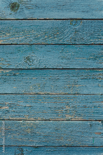 Vintage wood background with blue peeling paint.