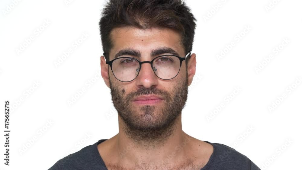 hispanic bearded guy in glasses with chest hair under grey t-shirt nodding positively being glad looking smart over white background. Concept of emotions