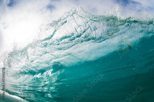 Water shot of a large wave breaking overhead.