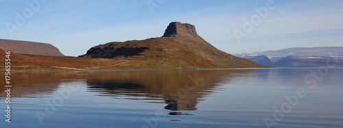 Hestfjoerdur, fjord in the north of Iceland. Mountain reflecting in the sea. Calm late summer day. photo