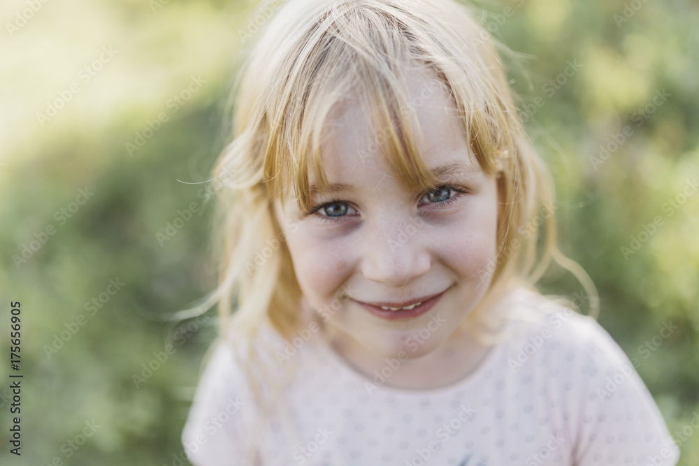 Happy young girl looking up at camera Happy young girl looking up at camera