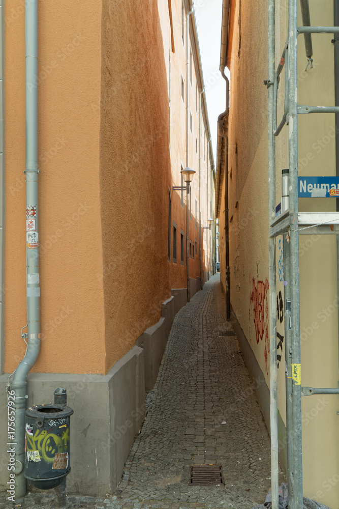 Narrow alley between neglected buildings