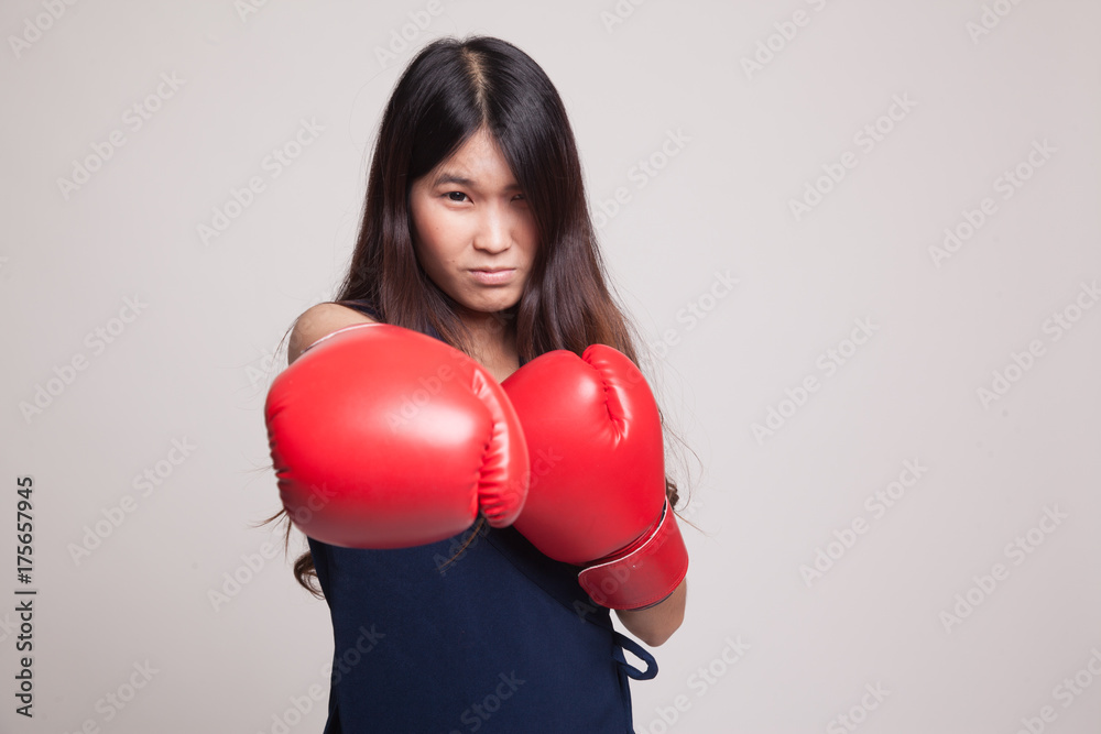 Young Asian woman with red boxing gloves. Young Asian woman with red boxing gloves.