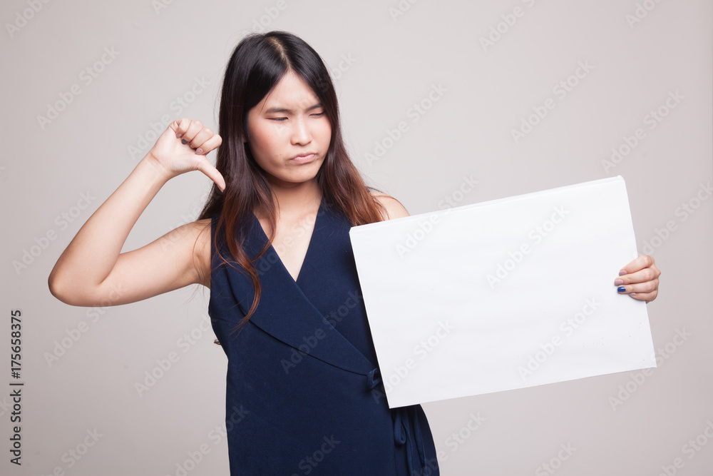 Young Asian woman show thumbs down with white blank sign. Young Asian woman show thumbs down with white blank sign.