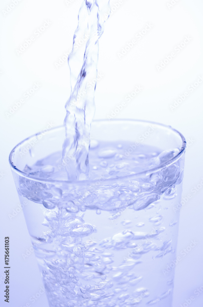 Pouring mineral water into a glass Pouring mineral water into a glass