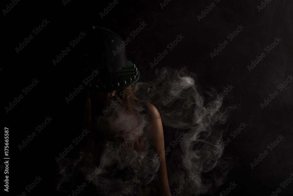 girl in snapback smokes