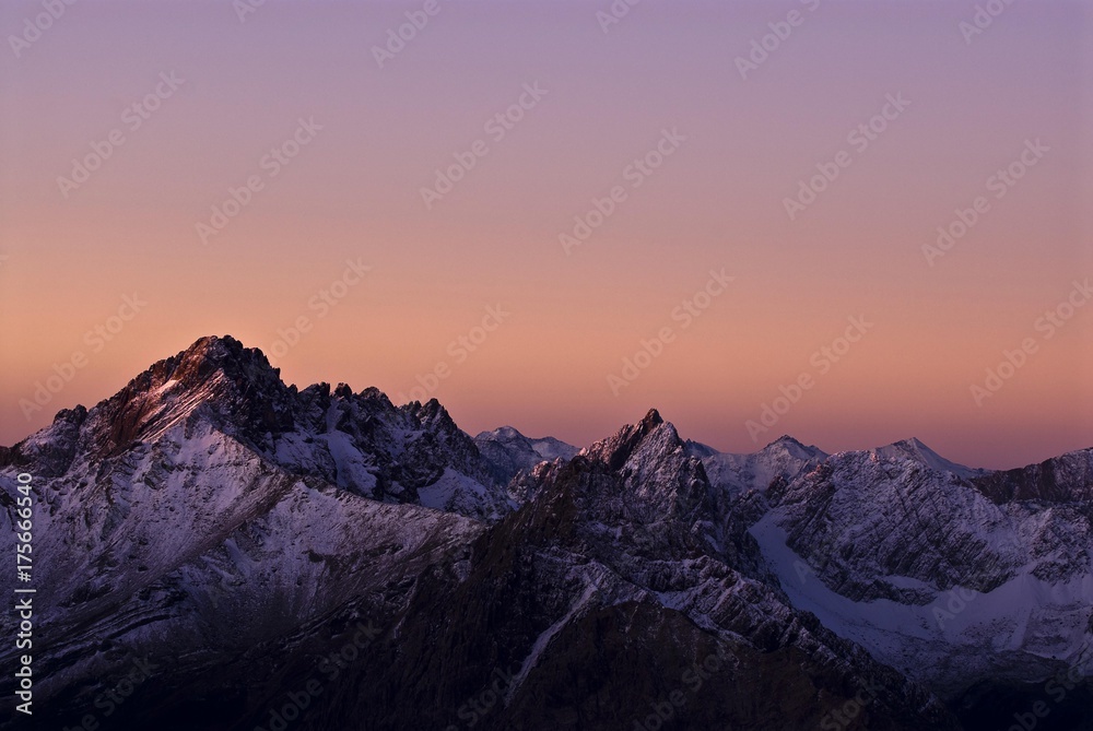 Fototapeta premium Sunrise with violet-coloured sky and snow-covered mountains, Namlos, Reutte, Tyrol, Austria, Europe