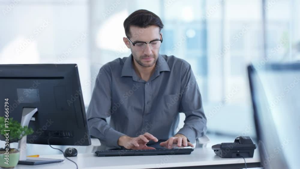  Cheerful businessman working at his desk in modern office
