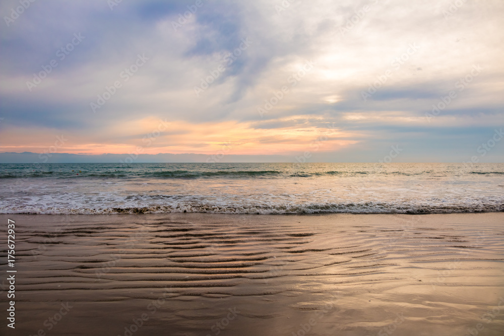 Fototapeta premium Sunset in Mexico with a beach and ocean. 