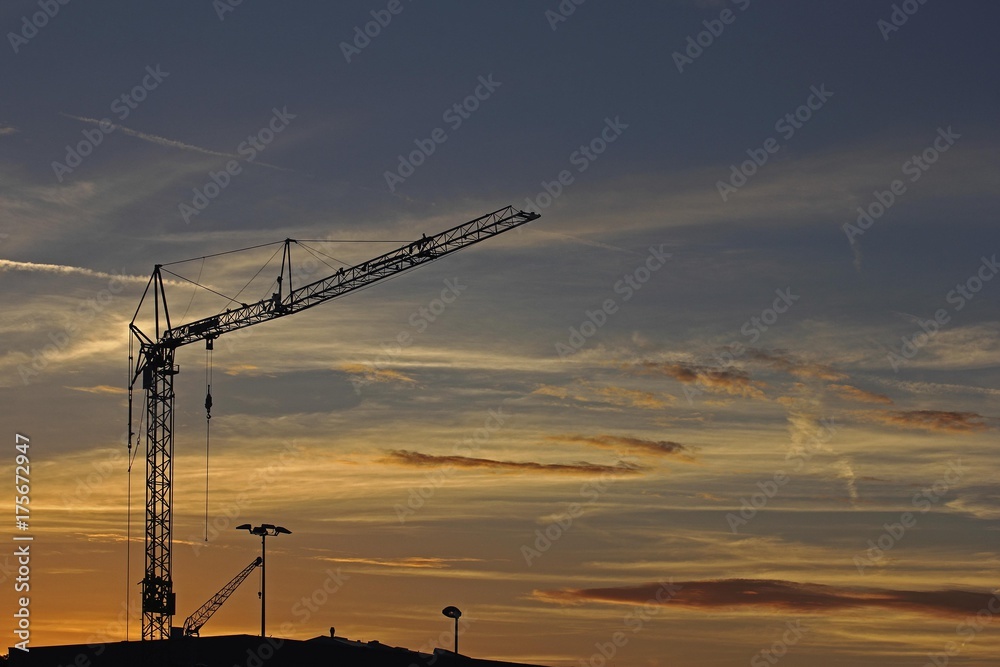 Construction crane against an evening sky, Baden-Wuerttemberg, Germany, Europe Construction crane against an evening sky, Baden-Wuerttemberg, Germany, Europe
