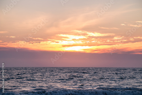 An orange sunset with blue ocean. 