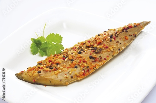 Smoked mackerel covered in pepper photo