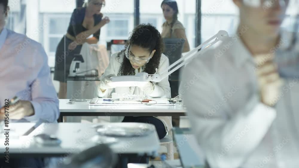 Electronics engineers working in lab building & testing motherboards Electronics engineers working in lab building & testing motherboards