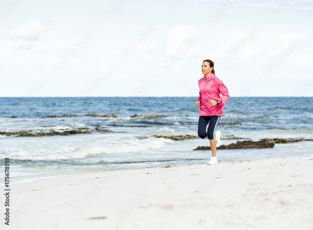 Young Woman Jogging On The Beach