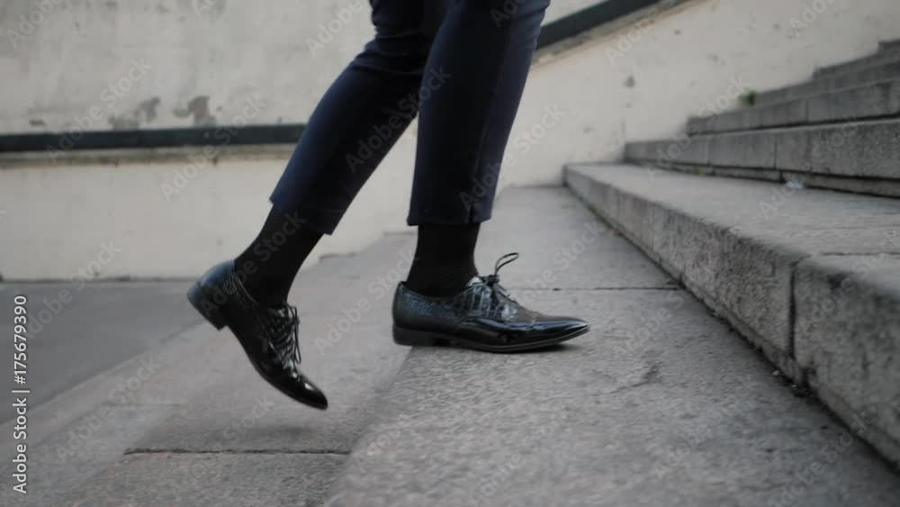 Businesswoman Legs In Black Leather Shoes Walking Up Stairs On Stairway. Sexy Woman near Office after Work. Student girl go to lessons. Slow motion