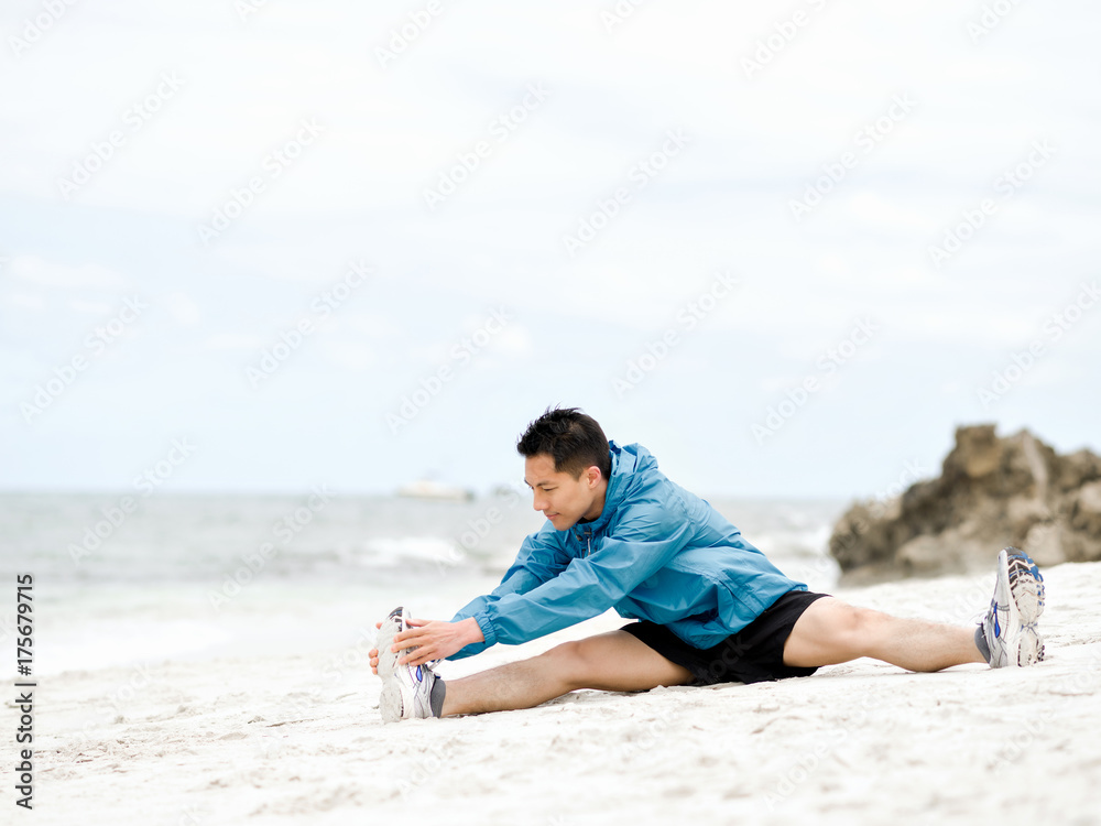 Young man doing exercise at the beach Young man doing exercise at the beach