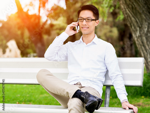 Businessman portrait with mobile phone outdoors