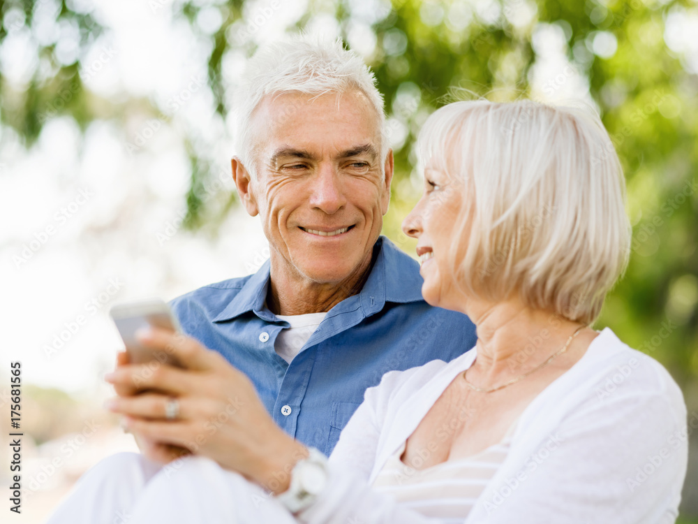 Happy senior couple looking at smartphone Happy senior couple looking at smartphone