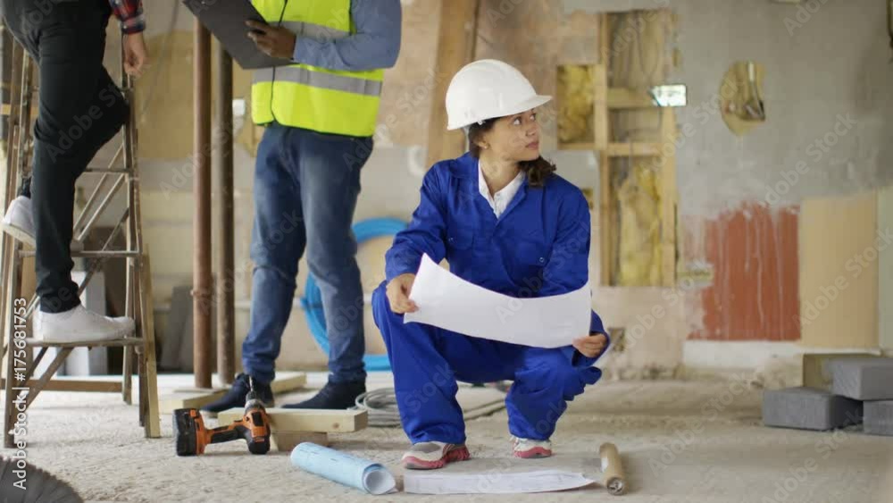 Architect or engineer having discussion with foreman at construction site Architect or engineer having discussion with foreman at construction site