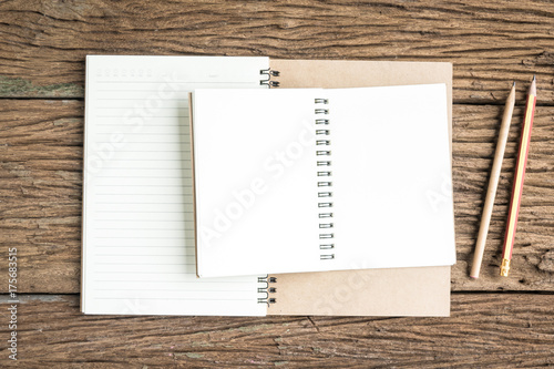 Top view notebook on rough wooden texture. Concept for education and business. Office top view background.