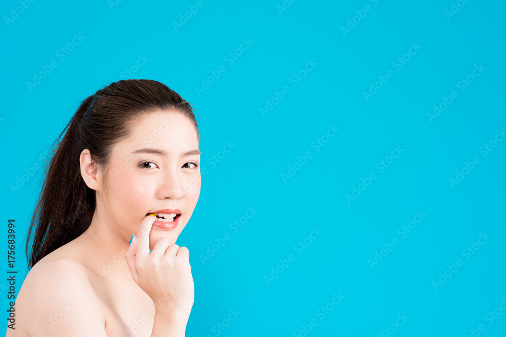 Young Asian woman flirting isolated on blue background. Young Asian woman flirting isolated on blue background.