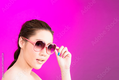 Young Asian woman with happy smile isolated on pink background.