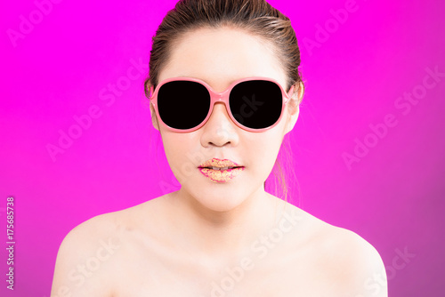 Young Asian woman with happy smile isolated on pink background.