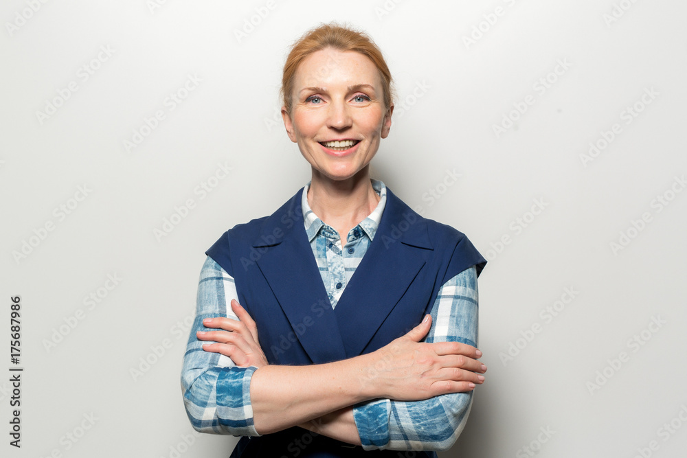 Pretty middle-aged woman with toothy smile looking at camera Pretty middle-aged woman with toothy smile looking at camera